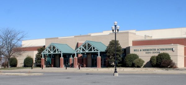 a photo of the front of the Paducah expo center in winter with bare trees and a blue sky in the background